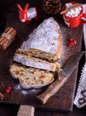Slice traditional European cake Stollen with nuts and candied fruit dusted with icing sugar