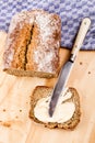 Slice traditional irish sodabread with butter on a wooden board