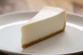 Slice of traditional new york cheesecake on white plate on wood table Royalty Free Stock Photo