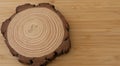 Slice of tree with annual circles and bark on a wooden background Royalty Free Stock Photo