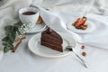 Slice of Triple Chocolate Ganache Cake and cup of tea on the table Royalty Free Stock Photo