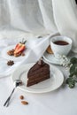 Slice of Triple Chocolate Ganache Cake and cup of tea on the table Royalty Free Stock Photo