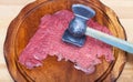 Slice of veal are beat by meat tenderizer