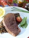 Slice of veal liver on a bed of lentils Royalty Free Stock Photo