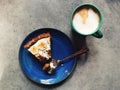Slice of vegan banoffee pie on plate with fork, espresso drink