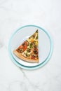 Slice of Vegan vegetable pizza. Dish with tomatoes, eggplant, champignons, Mozzarella cheese and basil pesto sauce. Royalty Free Stock Photo