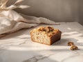 A slice of walnut bread on a marble surface, illuminated by soft natural light Royalty Free Stock Photo
