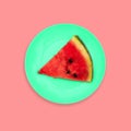 A slice of watermelon on a plate. Creative color background. Minimal style. A top view of a flat layout