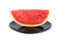 Slice watermelon in plate isolated on white background. Cut red watermelon in black dish isolated Royalty Free Stock Photo