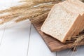 Slice wheat bread on white wood background