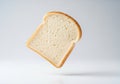 A slice of white bread floats against a plain background. The bread is evenly browned at the crust Royalty Free Stock Photo