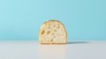 A slice of white bread with a golden crust sits on a white surface against a light blue background. Royalty Free Stock Photo