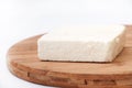 A slice of white feta cheese on a kitchen board Royalty Free Stock Photo