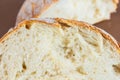 A slice of white fresh crispy bread on a brown background Royalty Free Stock Photo