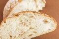 A slice of white fresh crispy bread on a brown background