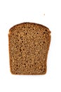 Slice of wholemeal dark bread isolated on a white background in close-up high details Royalty Free Stock Photo