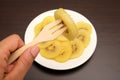 Slice of yellow kiwigold kiwi on plate. Royalty Free Stock Photo