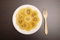 Slice of yellow kiwigold kiwi on plate. Royalty Free Stock Photo