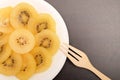 Slice of yellow kiwigold kiwi on plate. Royalty Free Stock Photo