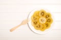 Slice of yellow kiwigold kiwi on plate. Royalty Free Stock Photo