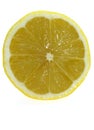 SLICE OF YELLOW LEMON citrus limonum AGAINST WHITE BACKGROUND Royalty Free Stock Photo