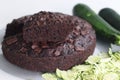 Slice of Zucchini chocolate cake on top of the round cake Royalty Free Stock Photo