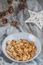 Sliced almonds on a ceramic bowl on christmas table.