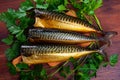 Sliced appetizing smoked mackerel with parsley closeup