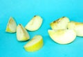 Sliced Apple on a blue background. Green Apple cut into pieces. Fresh and healthy fruits. Fresh green apples.