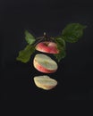 A sliced apple flies on a black background. Royalty Free Stock Photo