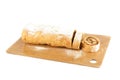 Sliced apple strudel on a wooden cutting board over white background. Royalty Free Stock Photo