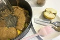 Sliced apples and dough in a baking dish. Charlotte ingredients and tools. Autumn pie with apples