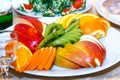 Sliced apples, oranges on a table