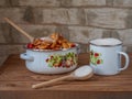 Sliced apples to prepare for cooking jam, sugar in a deep mug and wooden spoons on the table Royalty Free Stock Photo