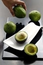 Sliced avocado and hand picking up an avocado Royalty Free Stock Photo