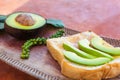 Sliced avocado on toast bread with fresh peppercorn.