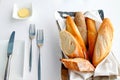 Sliced baguette with butter and knife