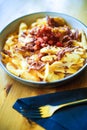 Sliced baked potatoes with ham and cheese, on a plate