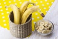 Sliced banana in bowl on white wooden background. Royalty Free Stock Photo