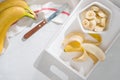 A sliced banana in a bowl on wooden background Royalty Free Stock Photo