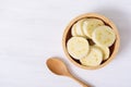 Sliced banana in a bowl and wooden spoon Royalty Free Stock Photo