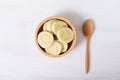 Sliced banana in a bowl and wooden spoon Royalty Free Stock Photo