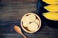 Sliced banana in a bowl on wooden table Royalty Free Stock Photo