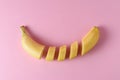 Sliced banana on pastel pink background. Minimal fruit concept