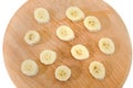 Sliced banana slices on a wooden board isolated on a white background. View from above. Royalty Free Stock Photo