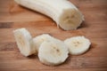 Sliced banana on wooden cutting board in bamboo textu