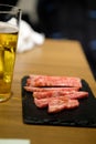 Sliced beef for barbecue grill with glass of beer