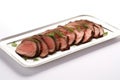sliced beef roast arranged on a white ceramic platter Royalty Free Stock Photo
