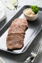 Sliced beef tongue with horseradish sauce. Close up