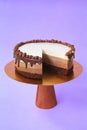 Sliced Birthday cake on the wooden cake stand. Beautiful sponge cake on the paper background. Copy space. Food photography for